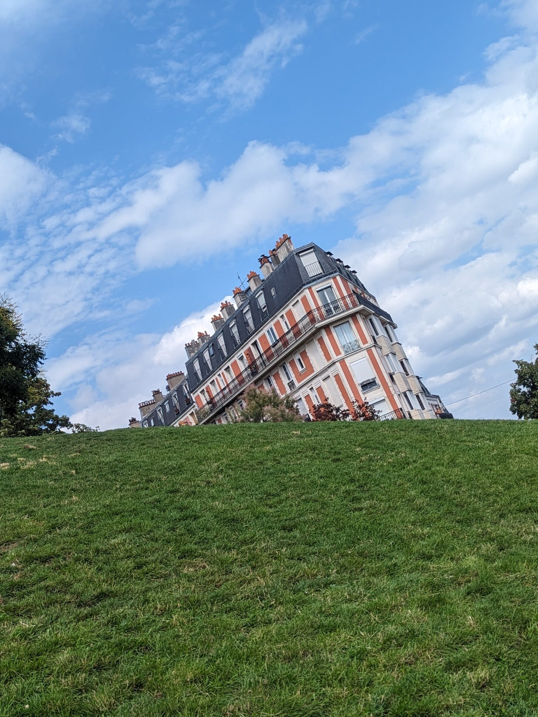 A pink house that appears to be sinking into the ground in Montmartre France